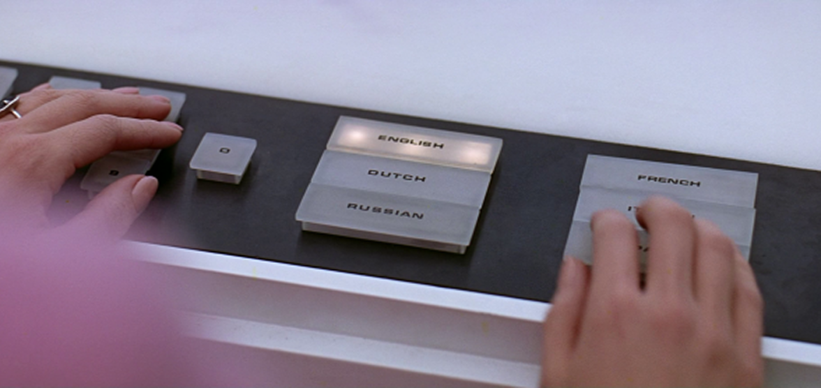 Close-up of three backlit buttons labeled ENGLISH, DUTCH, and RUSSIAN on a control panel.